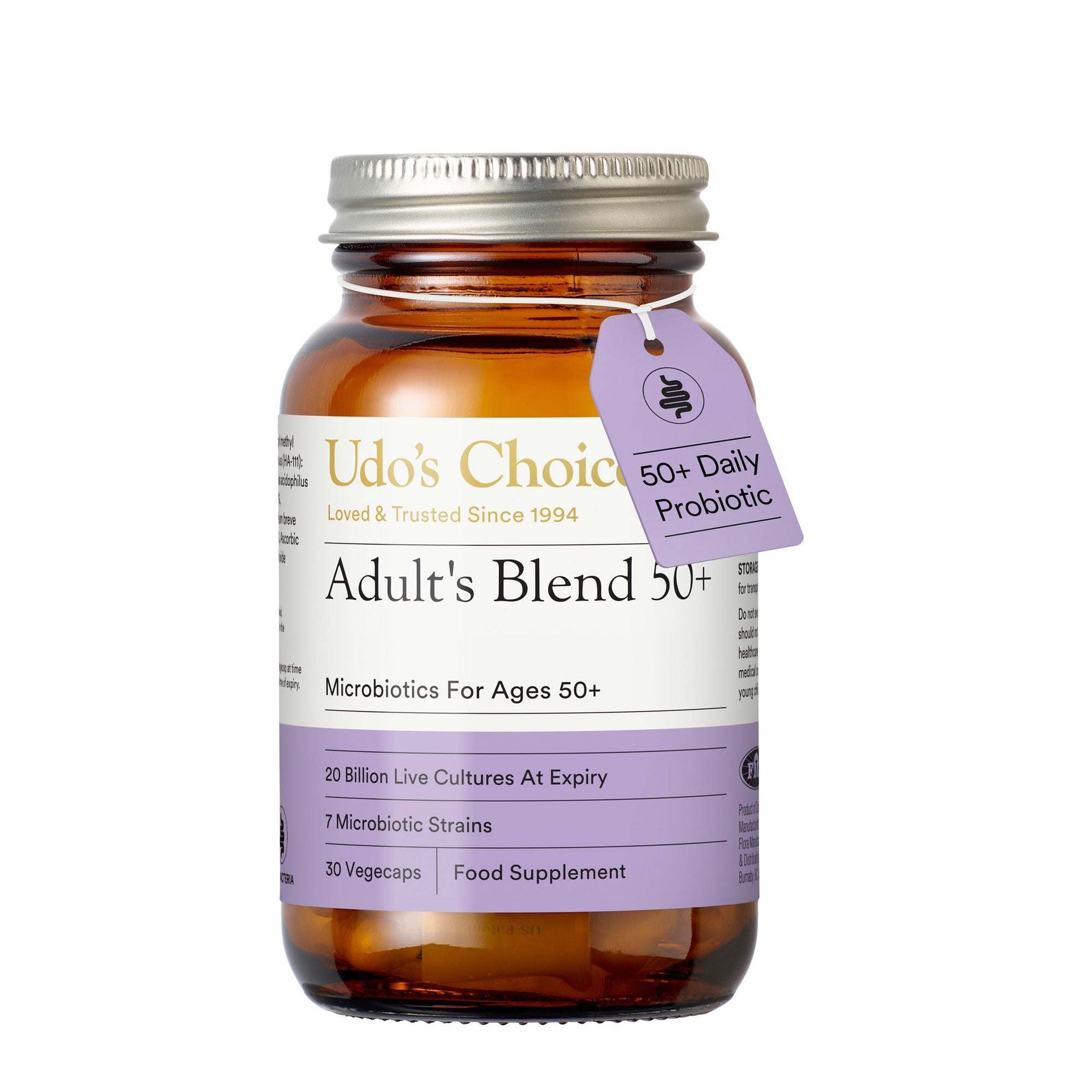 Udo's Choice Adult's Blend 50+ Microbiotics in an amber glass bottle with a silver metal cap and a purple hanging tag, shown on a white background.