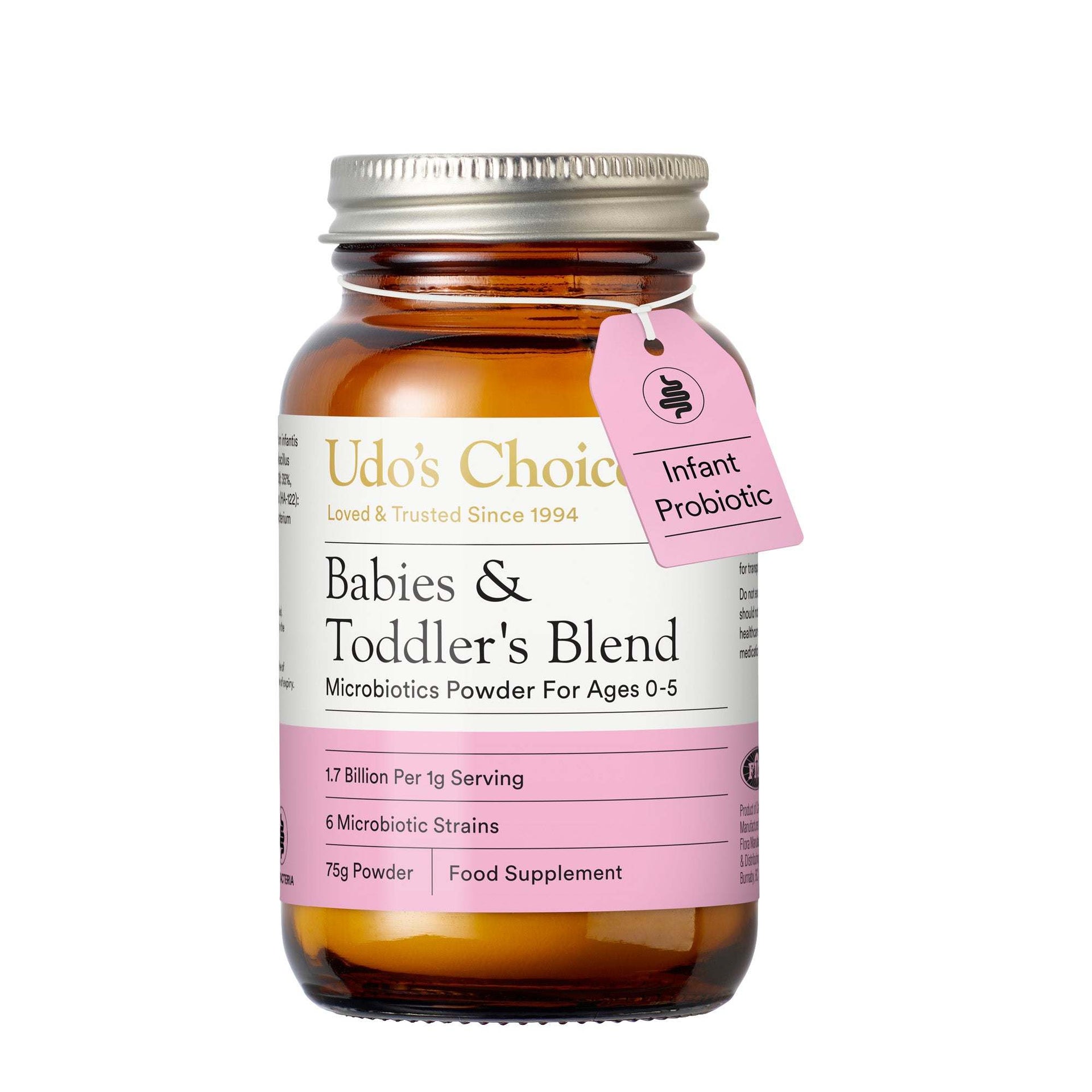 Udo's Choice Babies & Toddler's Blend Microbiotics Powder in an amber glass bottle with a silver metal cap and a pink hanging tag labeled Infant Probiotic, on a white background.