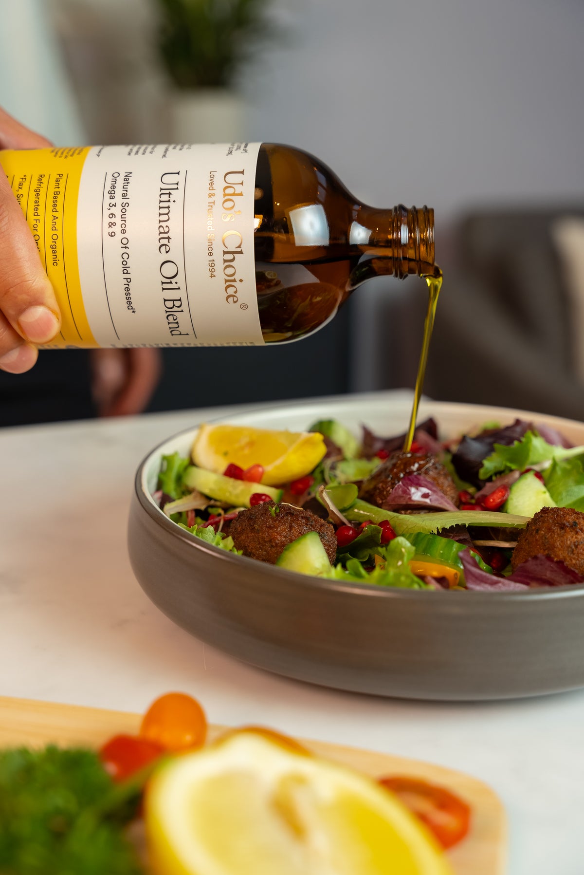 Ultimate Oil Blend Omega 369 being poured over a wholesome salad