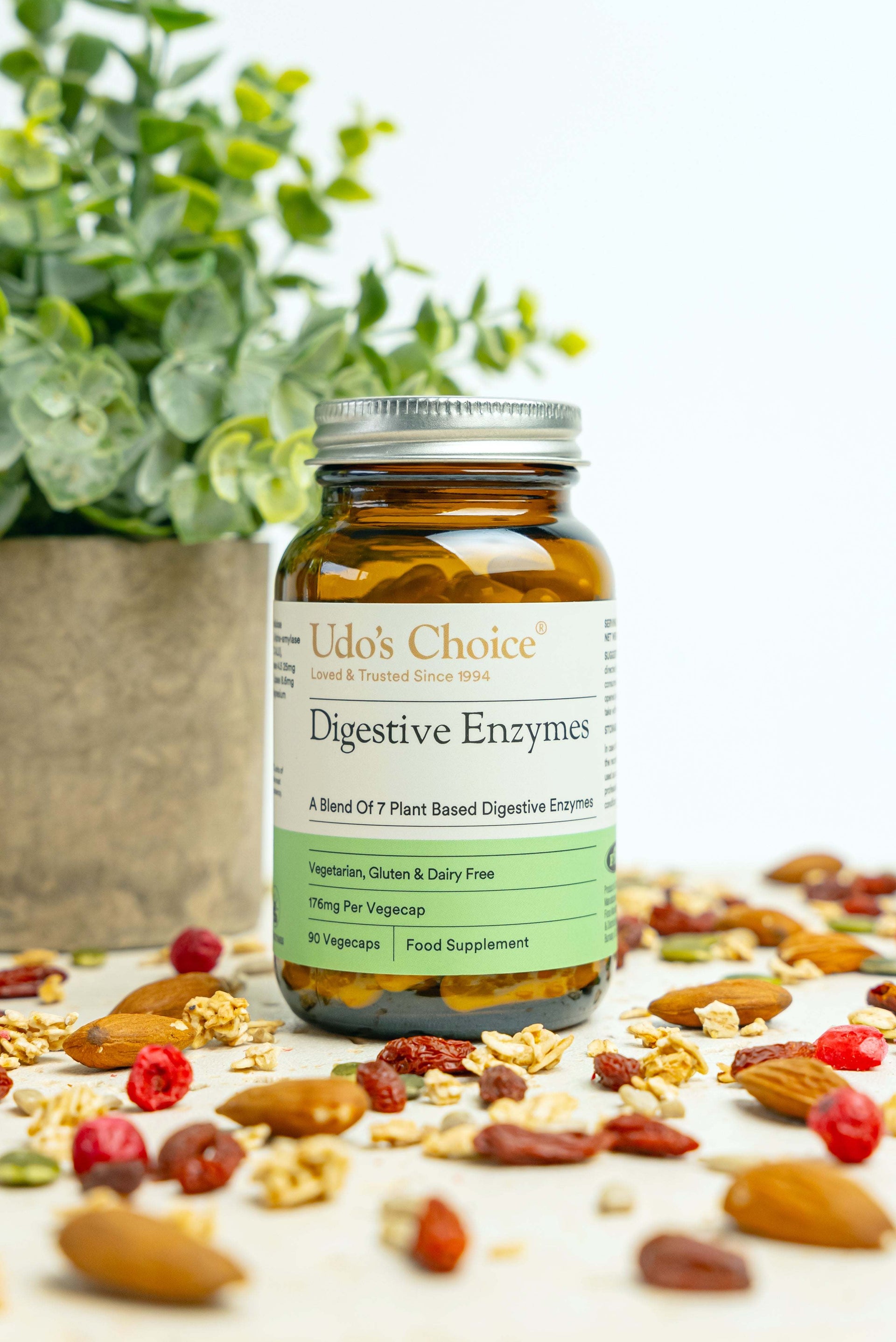 Udo's Choice Digestive Enzymes bottle with a background of nuts and berries
