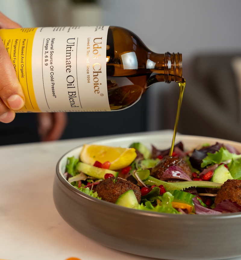 Ultimate Oil Blend Vegan Omega being poured over salad