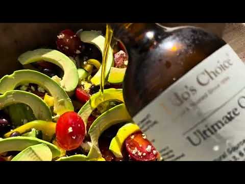 Ultimate Oil Blend being poured over a healthy salad as a dressing